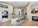 Bright kitchen with white cabinets, granite countertops, stainless steel appliances, and an island with seating at 3228 Country Club Pkwy, Castle Rock, CO 80108