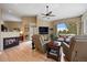Cozy living room with fireplace, hardwood floors, large windows, and comfortable seating at 3228 Country Club Pkwy, Castle Rock, CO 80108