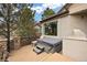 Outdoor patio features a hot tub, stainless steel grill, and wrought iron fence at 3228 Country Club Pkwy, Castle Rock, CO 80108