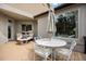 Outdoor patio features a firepit and dining table with chairs under a covered area at 3228 Country Club Pkwy, Castle Rock, CO 80108