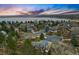 An aerial view of a neighborhood with a lake and sunset sky in the distance at 3053 Mcintosh Dr, Longmont, CO 80503