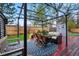 Outdoor dining area on a red deck featuring string lights, furniture, and a grill at 3053 Mcintosh Dr, Longmont, CO 80503