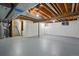 Spacious unfinished basement with exposed beams and painted concrete floor at 3053 Mcintosh Dr, Longmont, CO 80503
