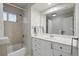 Bright bathroom featuring a shower over tub and a white vanity with ample storage space at 3053 Mcintosh Dr, Longmont, CO 80503