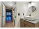 Stylish powder bathroom features a modern vanity and stackable washer and dryer at 3053 Mcintosh Dr, Longmont, CO 80503