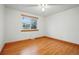 Bright bedroom with wood-look flooring and a large window at 3053 Mcintosh Dr, Longmont, CO 80503
