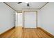Bedroom with hardwood floors, white walls, and a closet with sliding doors at 3053 Mcintosh Dr, Longmont, CO 80503