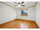 Bedroom with hardwood floors, ceiling fan, and a large window at 3053 Mcintosh Dr, Longmont, CO 80503
