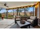 Cozy screened-in patio with comfortable seating and a view of the landscaped backyard at 3053 Mcintosh Dr, Longmont, CO 80503