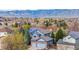 Aerial view of a home with mountain views shows solar panels and a brick garage at 10047 Sylvestor Rd, Highlands Ranch, CO 80129