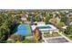 Aerial view of community amenities including a tennis court, a swimming pool, and parking at 10047 Sylvestor Rd, Highlands Ranch, CO 80129