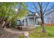 Backyard features a stone path, bench, grassy lawn and mature trees at 10047 Sylvestor Rd, Highlands Ranch, CO 80129