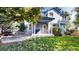Backyard shows a well-manicured lawn, patio with seating, landscaping and leafy trees at 10047 Sylvestor Rd, Highlands Ranch, CO 80129