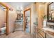 Spacious bathroom featuring dual sinks with granite countertops and decorative wallpaper at 10047 Sylvestor Rd, Highlands Ranch, CO 80129