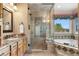 Elegant bathroom featuring a tiled shower, separate soaking tub and stylish vanity with marble countertop at 10047 Sylvestor Rd, Highlands Ranch, CO 80129
