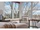 Cozy bedroom nook with large windows providing natural light and lovely view of tree limbs at 10047 Sylvestor Rd, Highlands Ranch, CO 80129