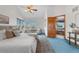 Inviting bedroom featuring a cozy sitting area and an open door to the Primary bathroom at 10047 Sylvestor Rd, Highlands Ranch, CO 80129