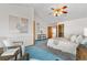 Spacious bedroom with high ceilings, featuring a sitting area with an abstract art on the wall at 10047 Sylvestor Rd, Highlands Ranch, CO 80129