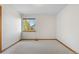 Bright and airy bedroom with neutral carpet, white walls and a window overlooking the yard at 10047 Sylvestor Rd, Highlands Ranch, CO 80129