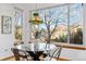 Breakfast nook features a glass table and chairs, with large windows providing natural light and views at 10047 Sylvestor Rd, Highlands Ranch, CO 80129