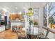 Bright dining area with stainless steel appliances, wooden cabinets, and breakfast bar at 10047 Sylvestor Rd, Highlands Ranch, CO 80129