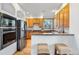 Well-lit kitchen features stainless steel appliances, granite countertops, and wooden cabinets at 10047 Sylvestor Rd, Highlands Ranch, CO 80129