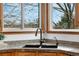 Kitchen sink area with granite countertops and a view of the landscape through the window at 10047 Sylvestor Rd, Highlands Ranch, CO 80129