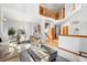 Bright, open-concept living and dining area with hardwood floors and a staircase at 10047 Sylvestor Rd, Highlands Ranch, CO 80129
