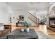 Open-concept living room with hardwood floors, staircase, and views of the dining area and fireplace at 10047 Sylvestor Rd, Highlands Ranch, CO 80129