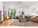 Inviting living room features hardwood floors, comfortable seating, a stylish rug, and bright natural light at 10047 Sylvestor Rd, Highlands Ranch, CO 80129