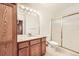 Well-lit bathroom features a vanity with granite countertop and a glass-enclosed shower at 1526 Peach Ct, Brighton, CO 80601