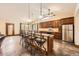 Modern kitchen features a large island with bar seating, stainless steel appliances, and granite countertops at 1526 Peach Ct, Brighton, CO 80601