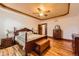 Main bedroom with hardwood floors, ceiling fan, classic furniture and a door leading to another room at 1526 Peach Ct, Brighton, CO 80601