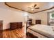 Inviting main bedroom with a fireplace, hardwood floors, ceiling fan and classic wood furniture at 1526 Peach Ct, Brighton, CO 80601