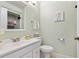 Clean and well-maintained powder room with a vanity, toilet, and soft green walls at 5027 E Barrington Ave, Castle Rock, CO 80104