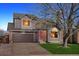 Charming two-story home with a two-car garage and a well-manicured front yard at 5027 E Barrington Ave, Castle Rock, CO 80104