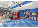 Organized two-car garage with vibrant walls, custom flooring, and plenty of space for storage and projects at 5027 E Barrington Ave, Castle Rock, CO 80104