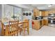 Eat-in kitchen featuring stainless steel appliances, light wood cabinets, and natural light at 5027 E Barrington Ave, Castle Rock, CO 80104