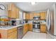 Well-maintained kitchen featuring stainless steel appliances and light wood cabinets at 5027 E Barrington Ave, Castle Rock, CO 80104