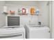 Laundry room featuring a washer, dryer, and shelving, designed for efficient organization at 5027 E Barrington Ave, Castle Rock, CO 80104