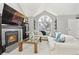 Bright living room featuring a fireplace, vaulted ceilings, and comfortable seating at 5027 E Barrington Ave, Castle Rock, CO 80104