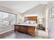 Comfortable primary bedroom featuring a vaulted ceiling, hardwood floors, and a large window for natural light at 5027 E Barrington Ave, Castle Rock, CO 80104