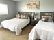 Comfortable bedroom with twin beds, carpet and light blue walls at 11328 W Radcliffe Dr, Littleton, CO 80127