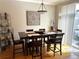 Cozy dining area with hardwood floors and a stylish light fixture at 11328 W Radcliffe Dr, Littleton, CO 80127