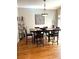 Cozy dining area with hardwood floors and a stylish light fixture at 11328 W Radcliffe Dr, Littleton, CO 80127