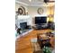 A comfortable living room with hardwood floors, a fireplace, and large windows providing natural light and warmth at 11328 W Radcliffe Dr, Littleton, CO 80127