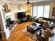Cozy living room featuring a fireplace, hardwood flooring, and large windows for natural light, creating a warm ambiance at 11328 W Radcliffe Dr, Littleton, CO 80127
