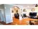 Spacious living room with a fireplace, hardwood floors and office space at 11328 W Radcliffe Dr, Littleton, CO 80127