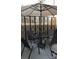 Relaxing outdoor patio with seating around a glass table under an umbrella at 11328 W Radcliffe Dr, Littleton, CO 80127