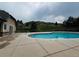 Community pool with a concrete deck, plus a view of a grassy hill and surrounding trees at 11328 W Radcliffe Dr, Littleton, CO 80127